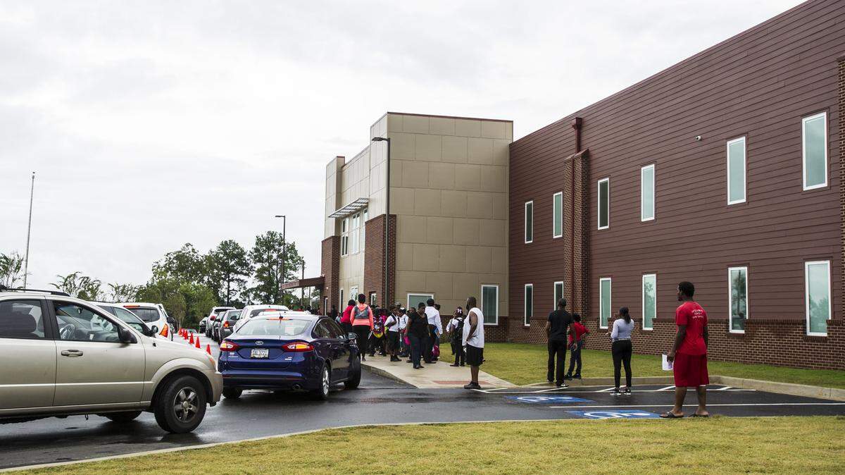 Parents wait outside Macon Charter Academy for school to be dismissed.