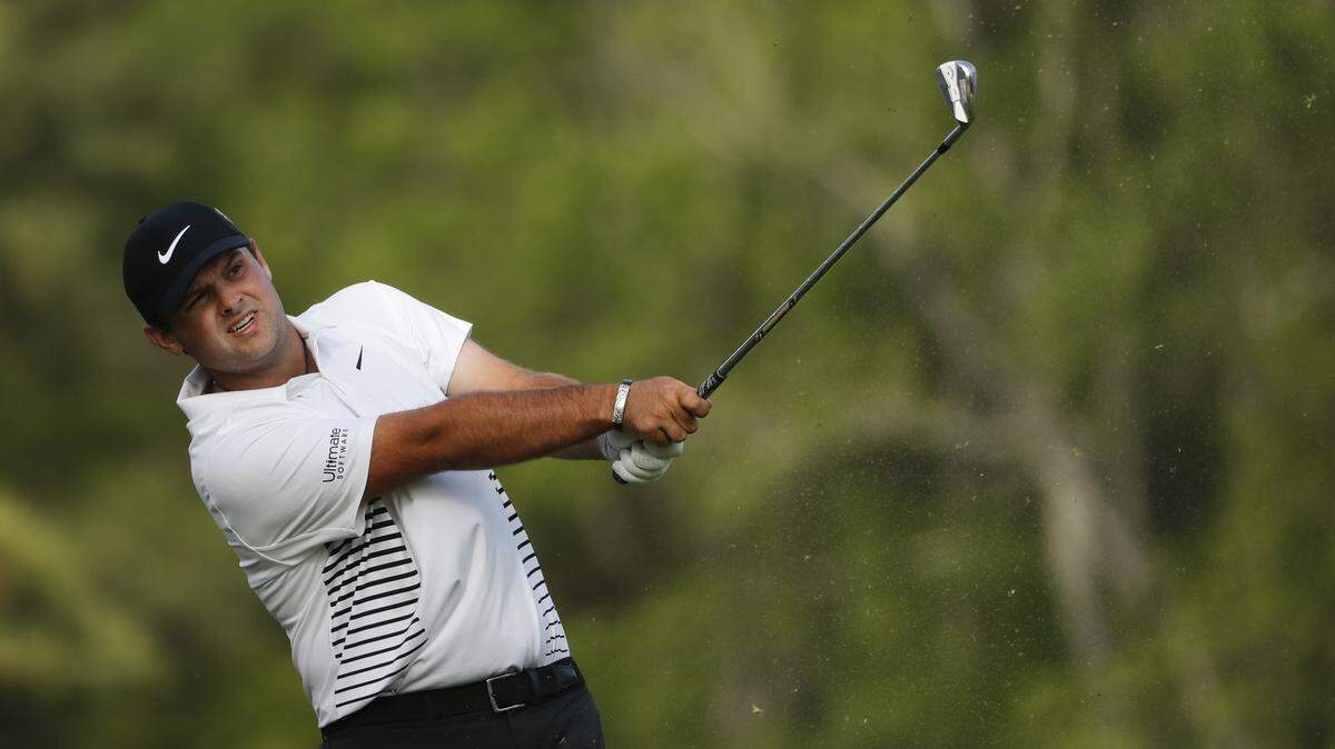 Patrick Reed hits a shot from the 12th tee during the second round at the Masters golf tournament Friday.