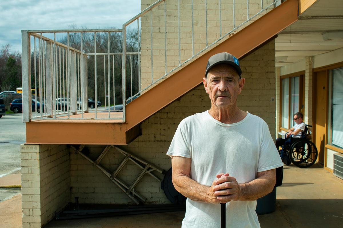 Bill Fuson moved from the now-demolished Magnolia Court to the hotel last April. Desire lines mark the path he walks regularly to the Piggly Wiggly on the other side of Interstate 75.