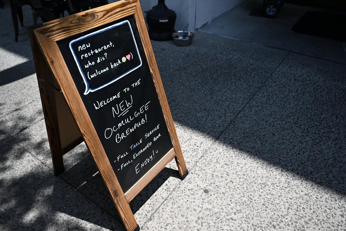 A sign advertising new renovations sits outside of Ocmulgee Brewpub on Wednesday, July 9, 2025, in downtown Macon, Georgia. The restaurant’s changes include a full service bar, sit-down only dining and new signage.