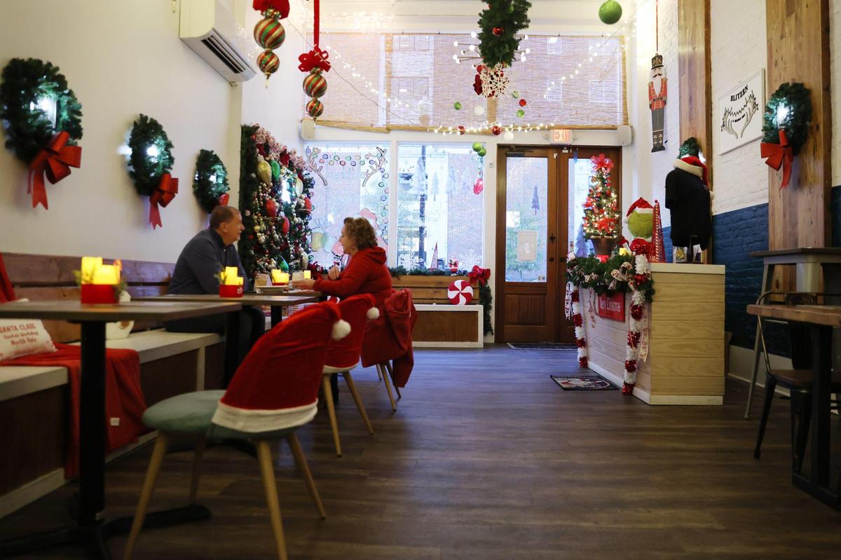 Patrons sit inside at Blitzen Bar, a holiday pop up bar inside of Sophia’s on Second on Thursday, Dec. 5, 2024, in Macon, Georgia. Blitzen Bar is one of two holiday themed pop up bars in Macon, which will be open through December with themed festive cocktails.
