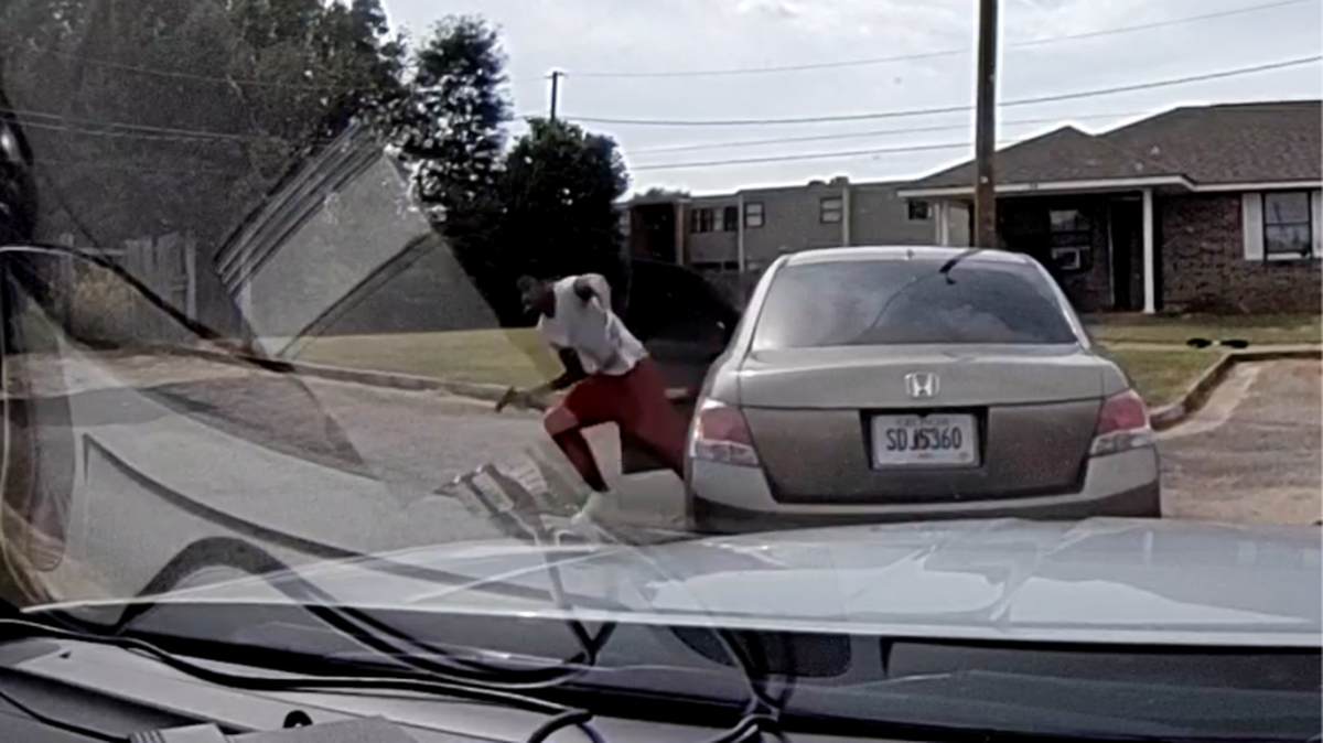 Picture from Sgt. Hermes Rodriguez's dash camera. Caleb Hooten can be seen exiting his vehicle, ahead of the patrol vehicle, with a gun in hand. 