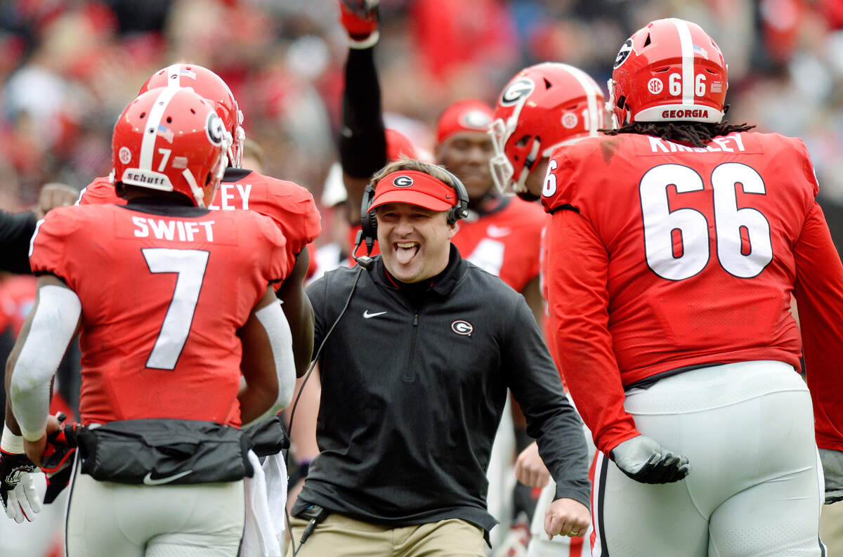 Georgia head coach Kirby Smart congratulates the Bulldog offense after a second quarter touchdown by Mecole Hardman (4) in their 45-21 win over Georgia Tech.