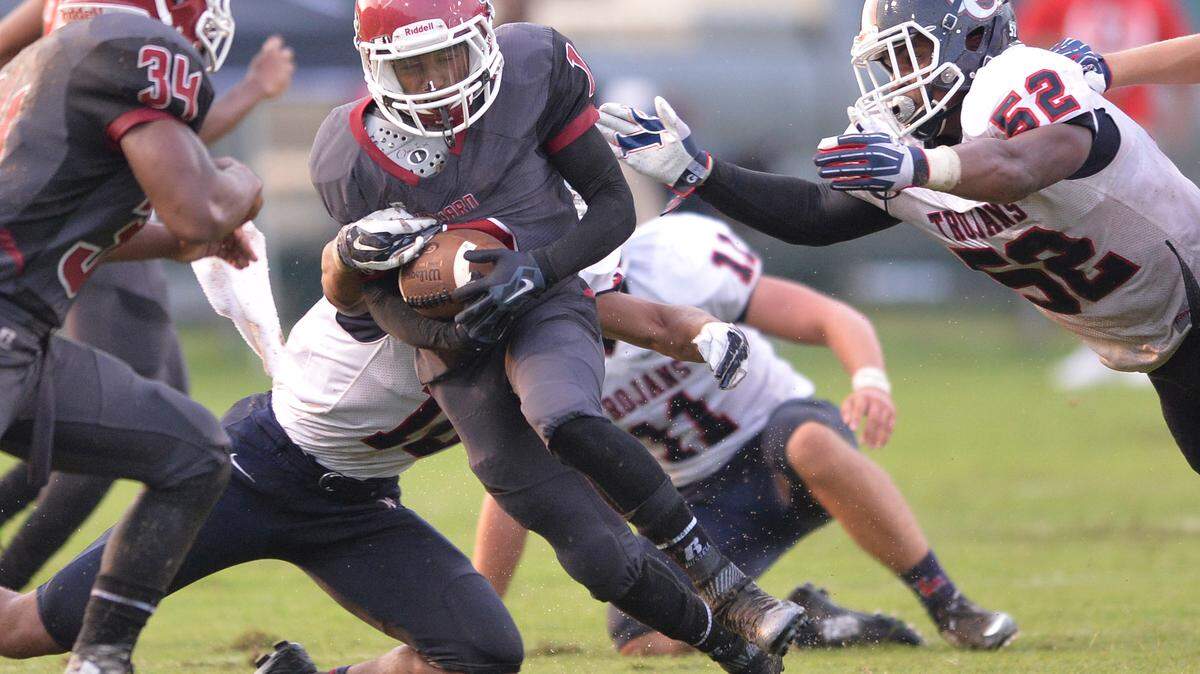Howard’s Jerin Means breaks a tackle and picks up a first down against Lamar County.