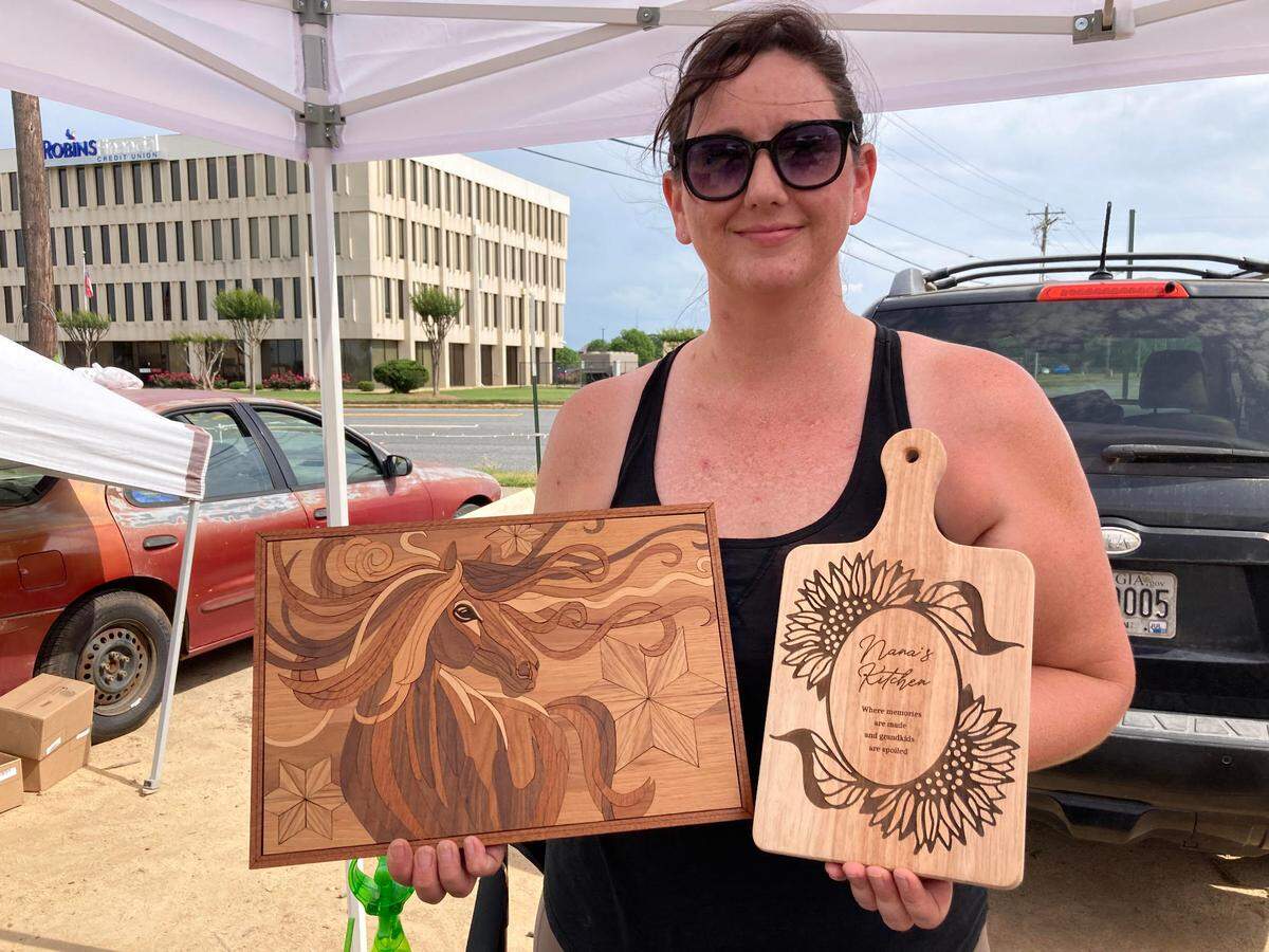 Samantha Gilbane of Kathleen, owner of The Burn Boutique, sells her laser cut gifts and decor at the International City Farmers Market in Warner Robins as well as online and on Etsy.