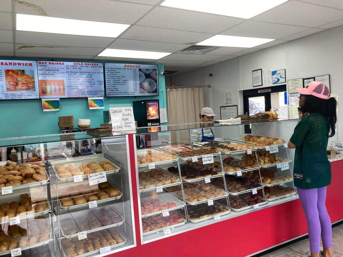 A customer checks out the menu at Ray’s Donuts in Warner Rboins.