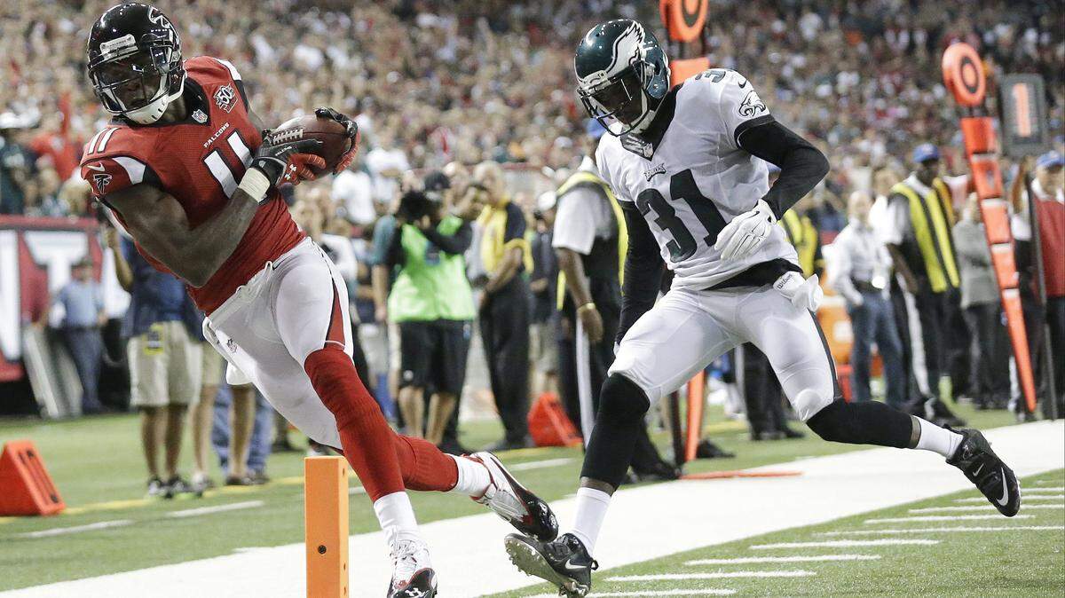 In this Sept. 14, 2015, file photo, Atlanta Falcons wide receiver Julio Jones (11) makes a touchdown catch against Philadelphia Eagles defensive back Byron Maxwell (31) during the first half of an NFL football game, in Atlanta. Julio Jones is on pace for one of the greatest receiving years in NFL history.