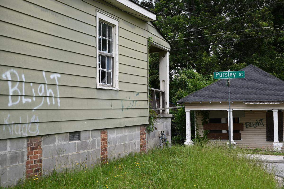 Two blighted houses sit off of Pursley Street in the Pleasant Hill neighborhood on Wednesday, July 2, 2025, in Macon, Georgia. Pleasant Hill residents are expected to live two decades less than Macon-Bibb County’s richest area, Idle Hour, according to data from the U.S. Census Bureau and Centers for Disease Control and Prevention.