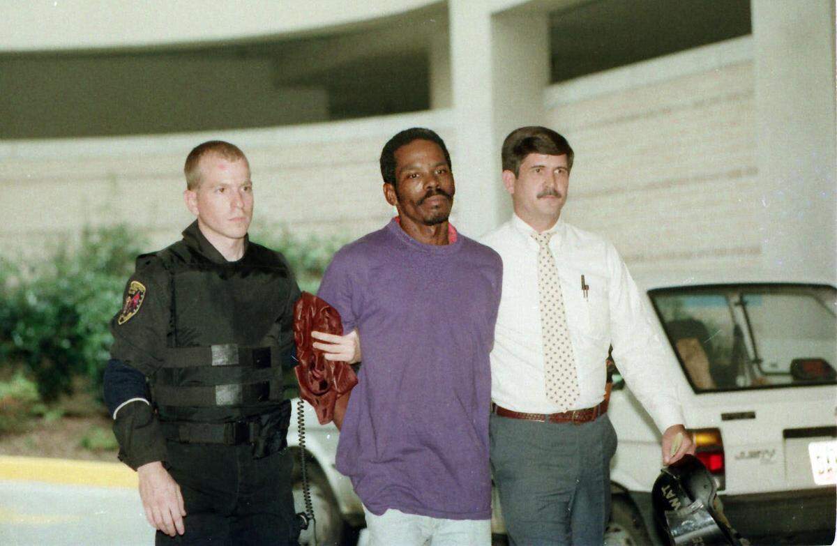 Lafayette Hall, second from left, is taken into custody by Macon police after he crashed into the Macon Mall and held cops at bay for hours.