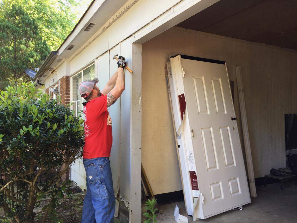 Rebuilding Macon volunteer Jason Kelly repairs the garage of a home in Kings Park during the organization’s annual Macon Rebuilding Day on April 27, 2019.