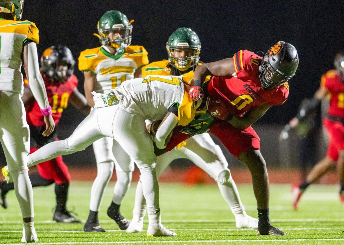 Northeast defender Amari White (0) stops Spencer running back Justyn Williams (7) during Friday night’s region matchup.