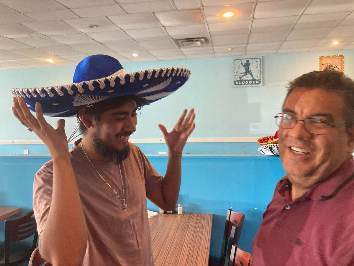 Taqueria Don Sammy owner Samuel “Sammy” Naranjo, right, and his eldest son, Samuel, joke around in the family restaurant at 1754 Watson Blvd. in Warner Roibns. The son works at Caniceria Tienda Don Sammy, a Mexican butcher shop and grocery store that the family recently opened in their former restaurant location at 1431 Watson Blvd.