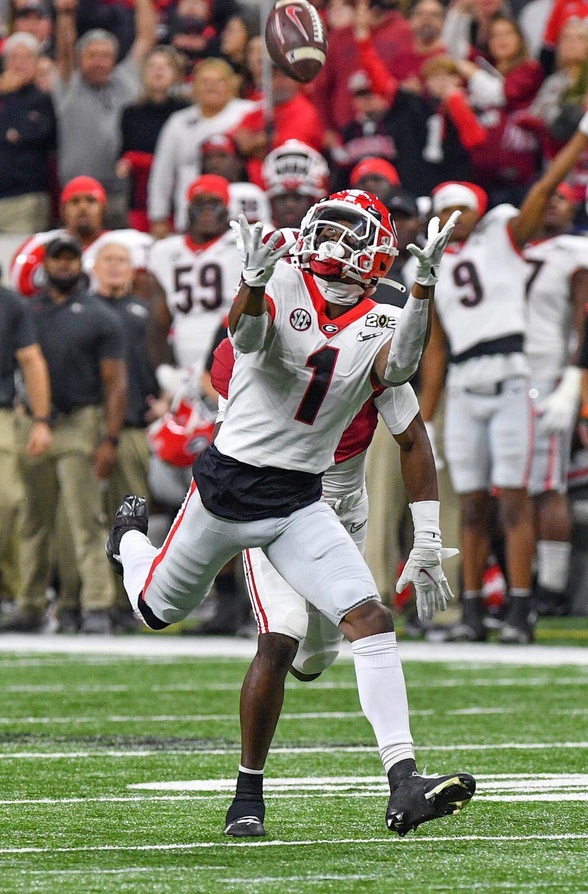 Georgia receiver George Pickens (1) hauls in a deep pass from quarterback Stetson Bennett (13) during the Bulldogs’ College Football Playoff National Championship game against Alabama Monday night.