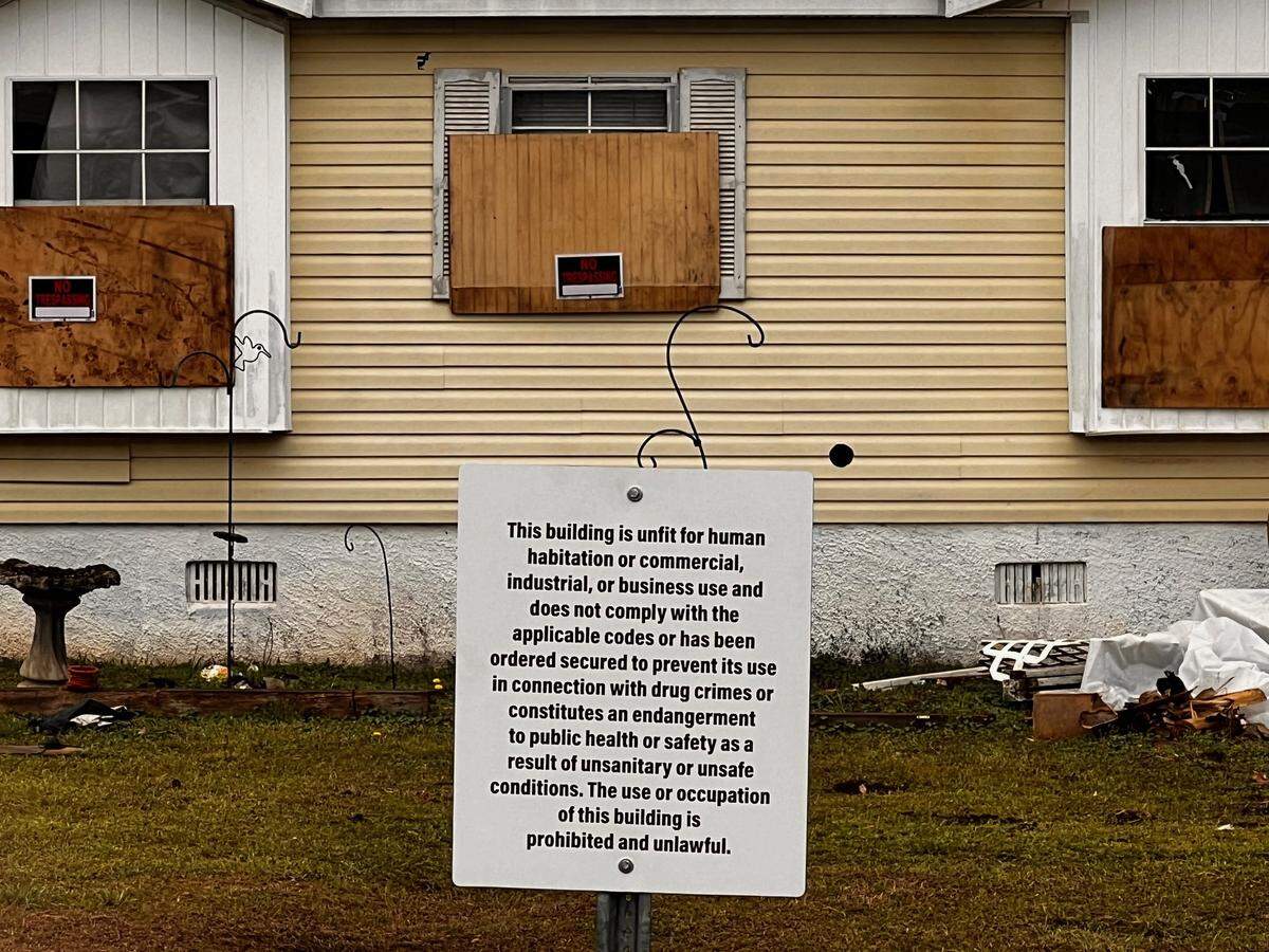 A sign posted in the front yard of a Houston County residence states the use or occupation of the building is prohibited and unlawful. The residence was deemed a public nuisance on March 1. 