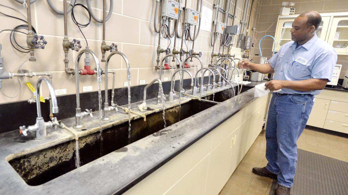 JASON VORHEES/THE TELEGRAPH Macon, GA, 06/25/2014: Customers of the Macon Water Authority are being warned of a telephone scam demanding money for phony arrears on their accounts. In this 2014 file photo, water plant operator Dale Morehead takes a sample at the Frank C. Amerson Jr. Water Treatment Facility.