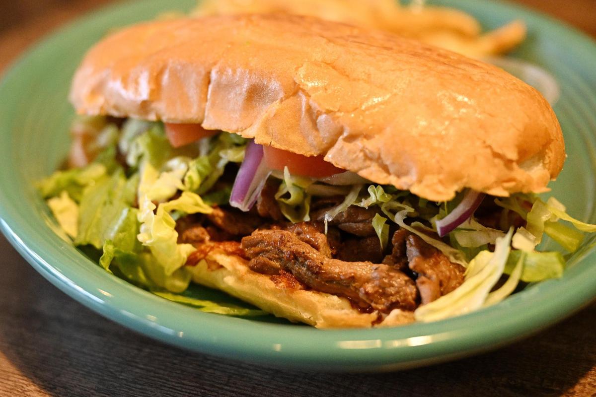 A Torta mexicana, which is a Mexican sandwich, sits on a table at Cozumel Mexican Grill on Wednesday, April 23, 2025, in Perry. This one was made with steak, lettuce, tomato, onions and guacamole with chipotle sauce on the side.