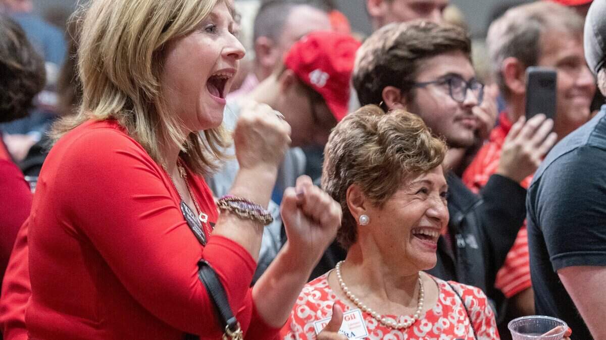 Brian Kemp supporters get excited as emcee Erick Erickson announces national results during an election night watch party Tuesday in Athens.