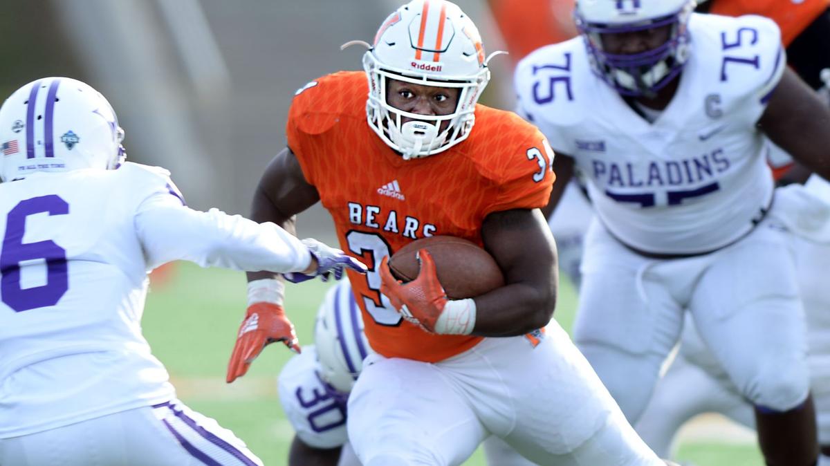 Mercer running back Tyray Devezin (34) finds enough running room in the Furman defense for a first-half first down.