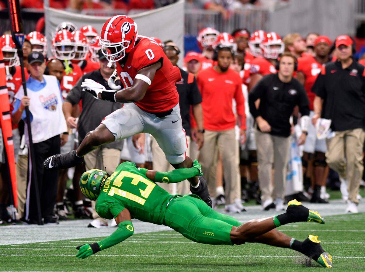 Georgia tight end Darnell Washington (0) leaps over an attempted tackle during the Bulldogs’ 49-3 win over Oregon Saturday in Atlanta.