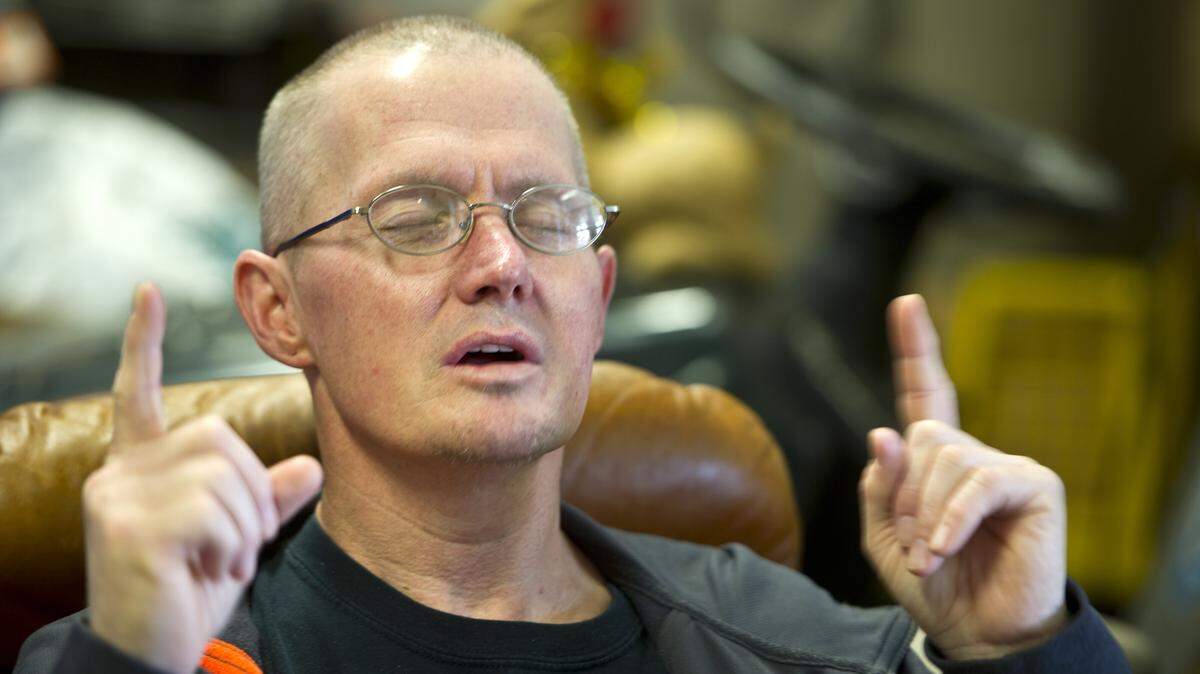 WOODY MARSHALL/THE TELEGRAPHKevin Peters sings "Come as You Are" while listening to the David Crowder song on a contemporary Christian music radio station while at his desk in the donation room at the Macon Rescue Mission.
