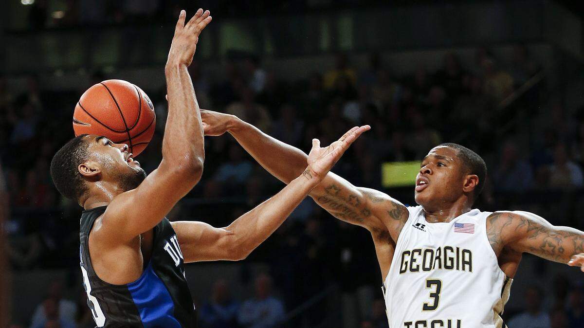 Georgia Tech guard Tadric Jackson (1) and Duke guard Matt Jones (13) vie for a rebound during the second half of Tuesday's game in Atlanta.