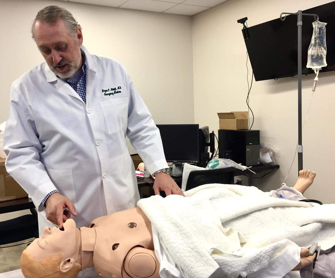 Dr. Bryan Sleigh, who oversees Coliseum Medical Centers’ residency programs, demonstrates treatment procedures on a dummy in the  hospital’s graduate medical education classroom on April 25. He’s excited for a new batch of residents, several from Caribbean medical schools, to start their training this summer.