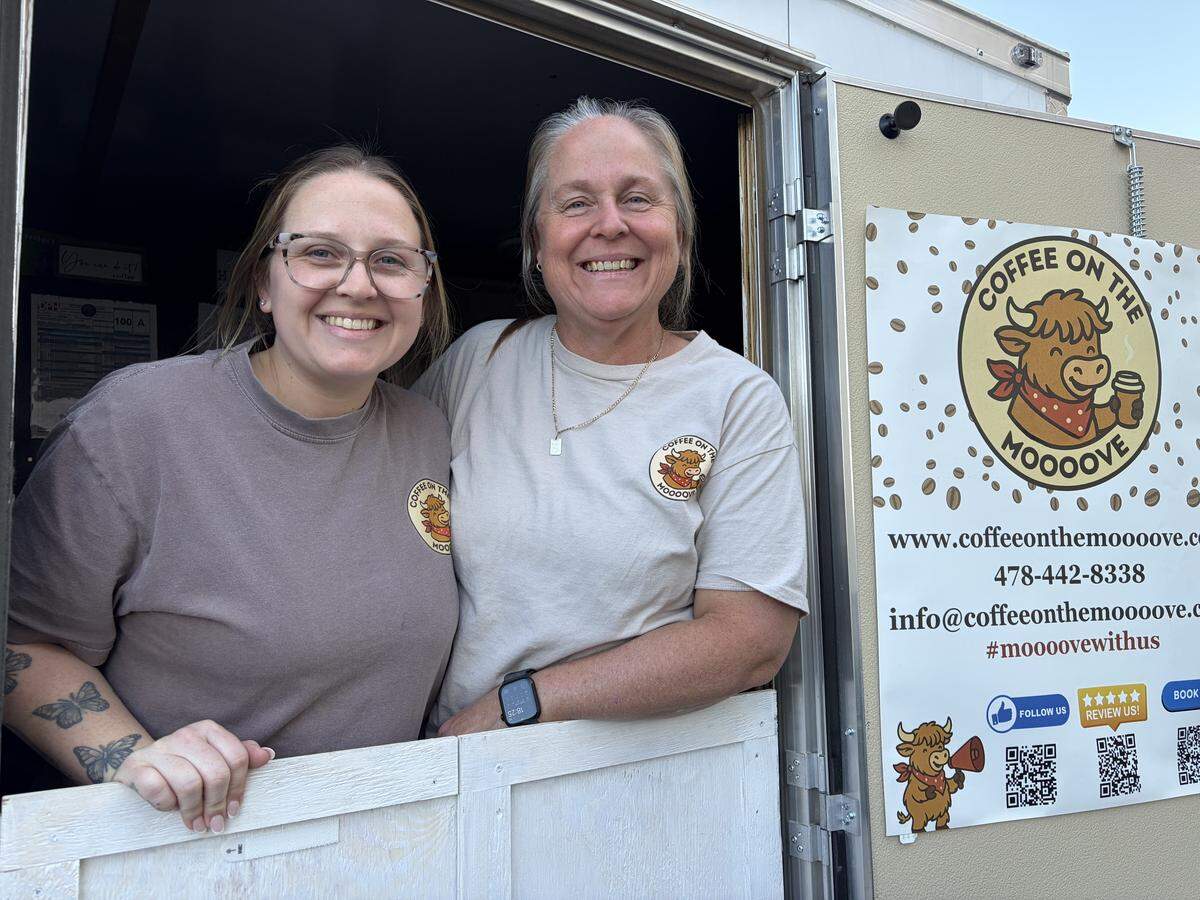 Ashley Lindstrom, left, and her mom, Collen Kemper, at the window of their Coffee on the Moooove trailer outside CrossFit Carnivore on Friday night, March 16, 2025.