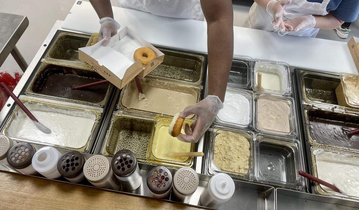 Customers can select coatings, toppings and drizzle for their fresh-made, warm doughnuts at Duck Donuts in Warner Robins.