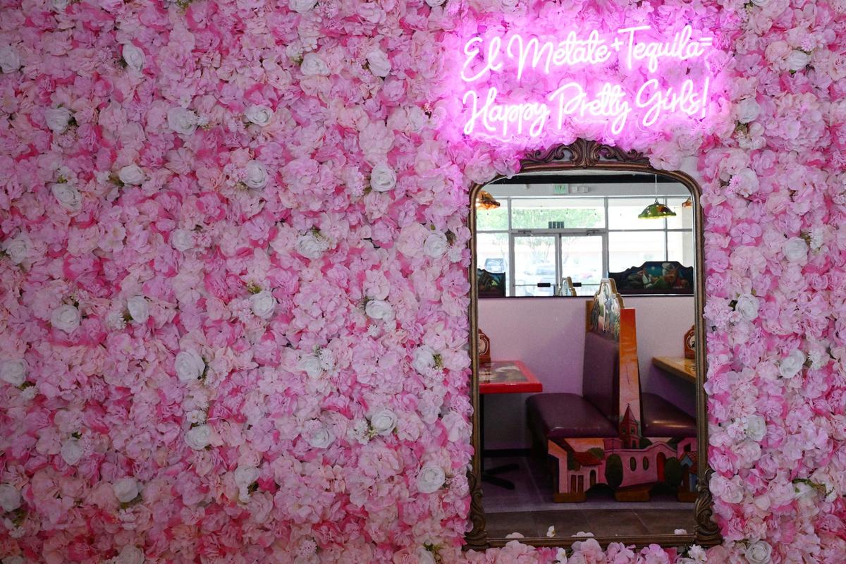A floral selfie wall with a mirror in the back of the new El Metate Mexican Restaurant on Wednesday, June 11, 2025, in Warner Robins.