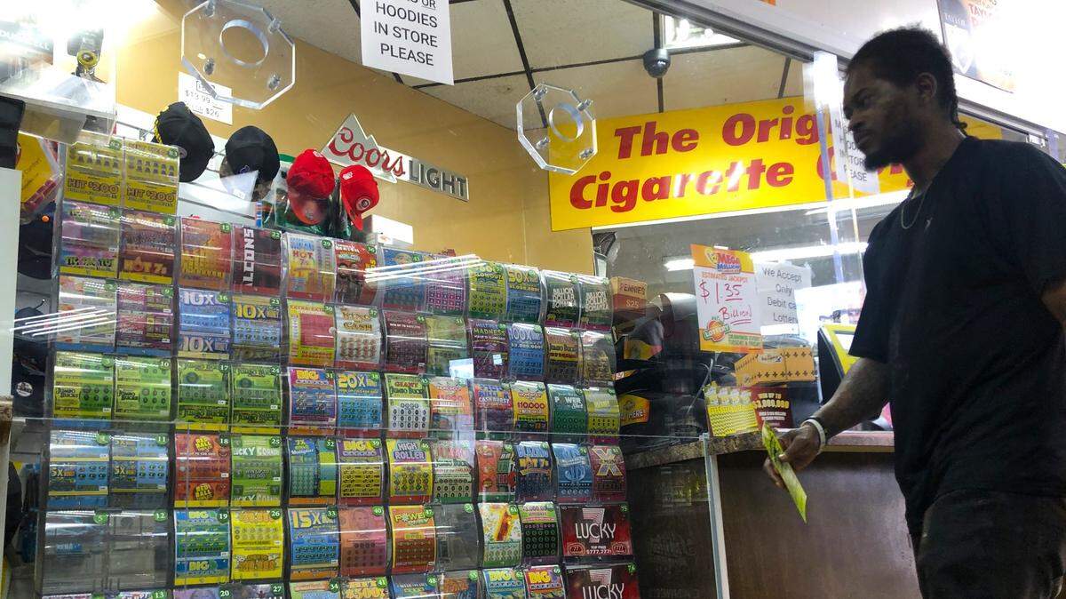 A customer eyes the scratch-off lottery selections at the LoLo Food Mart at the corner of Pio Nono Avenue and Eisenhower Parkway in Macon, Georgia. The store is the leading seller of lottery tickets in Bibb County.
