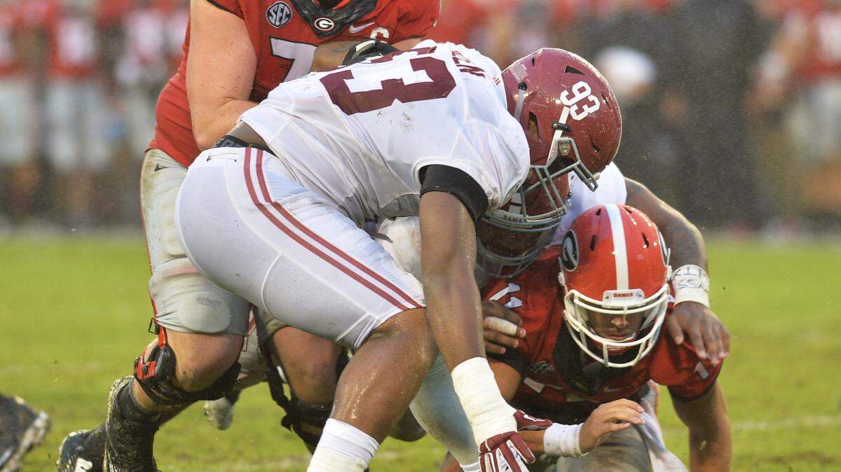 Georgia’s Greyson Lambert recovers his own second half fumble against Alabama. He completed 10-of-24 passes on the day for a total of 86 yards.