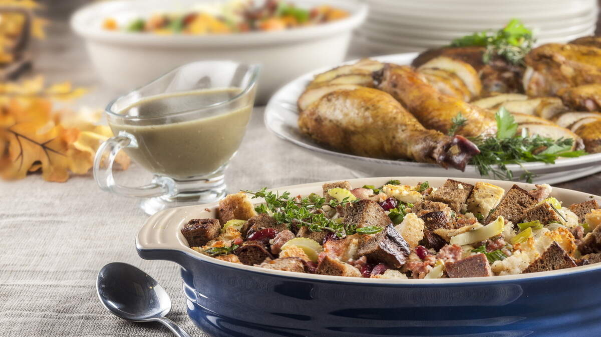 Two flavor-packed additions to your menu: Two-bread stuffing with sausage, bacon and raisins, and roasted sweet potatoes with smoked almonds and candied bacon.