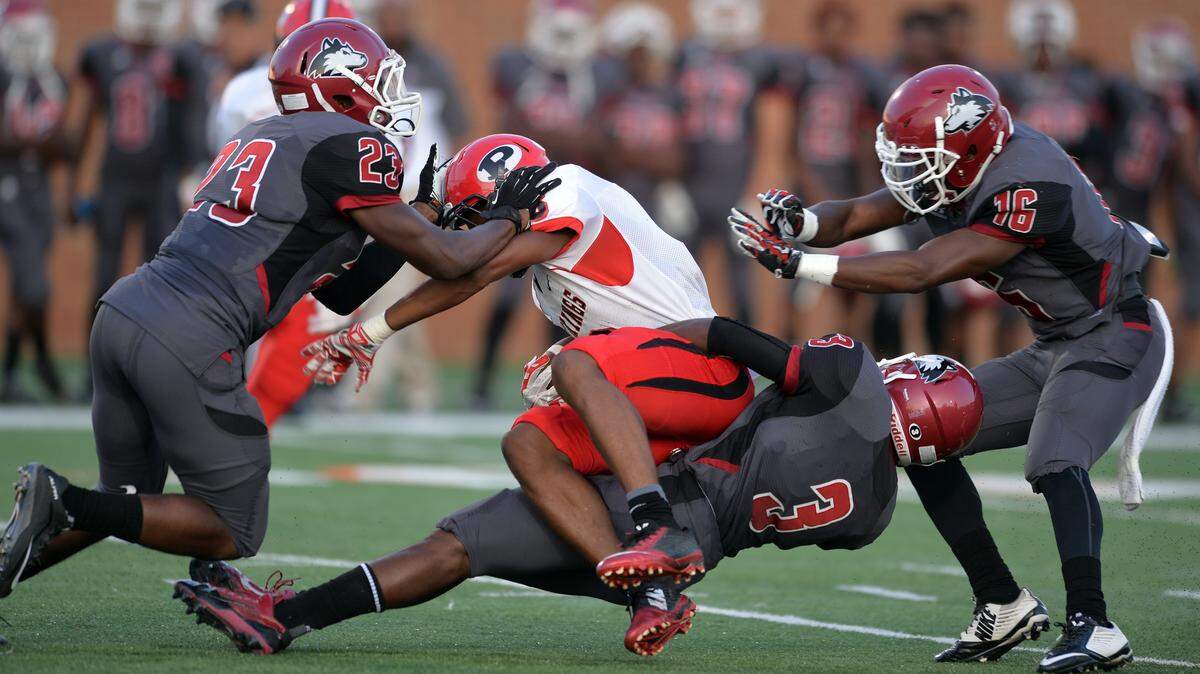 FPD’s Armaun Smith gets hauled down by Howard defenders (23) Stephon Harris, (16) Quintarious Jackson and (3) Robert Jarrell.