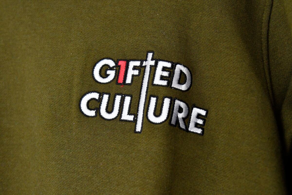 The G1fted Culture logo sits on a sweatshirt in Lace Era on Thursday, June 6, 2024, in Macon, Georgia. G1fted Culture is a faith-based apparel brand created in Macon that aims to inspire people to show off their God-given talents through fashion statements.