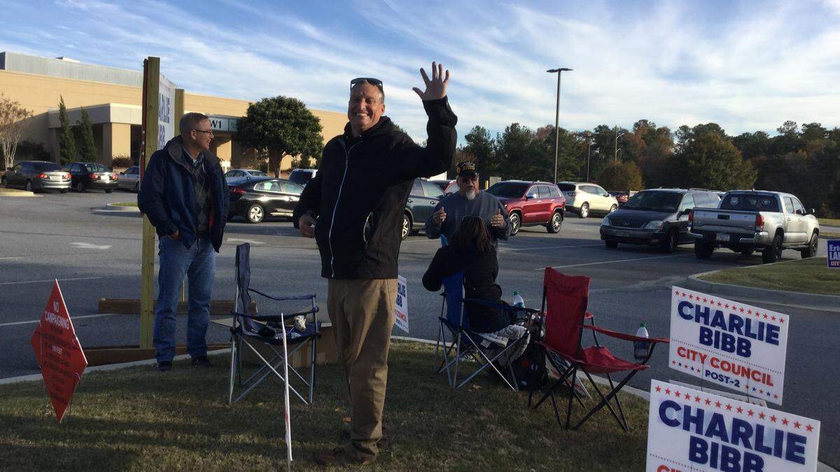 Charlie Bibb waves outside the Houston Healthcare Pavilion Conference Center polling place Tuesday before polls close in the runoff election between himself and Eric Langston for the at-large Post 2 seat on Warner Robins council.