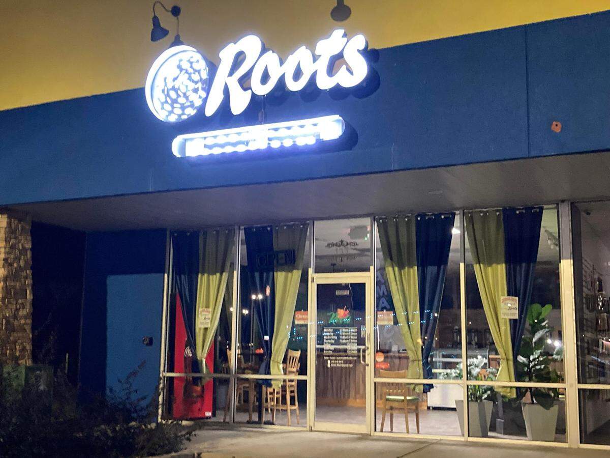 Crooklyn Roots, a new Jamaican and vegan restaurant, at 100 Hamilton Pointe Drive, Suite 155, in Byron, pictured at night.