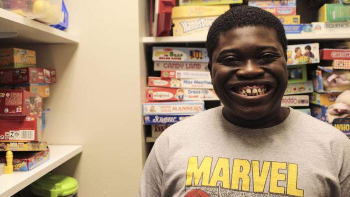 Jaqavius Gordon, 15, flashes a smile as he works on picking a game to play with his speech therapist at the Autism and Development Center, Navicent Health, in Macon.