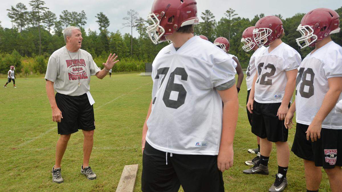 BEAU CABELL/THE TELEGRAPH 
 Macon, Ga., 07/3 1/2015: Howard coach Barney Hester works with his offensive linemen during practice.