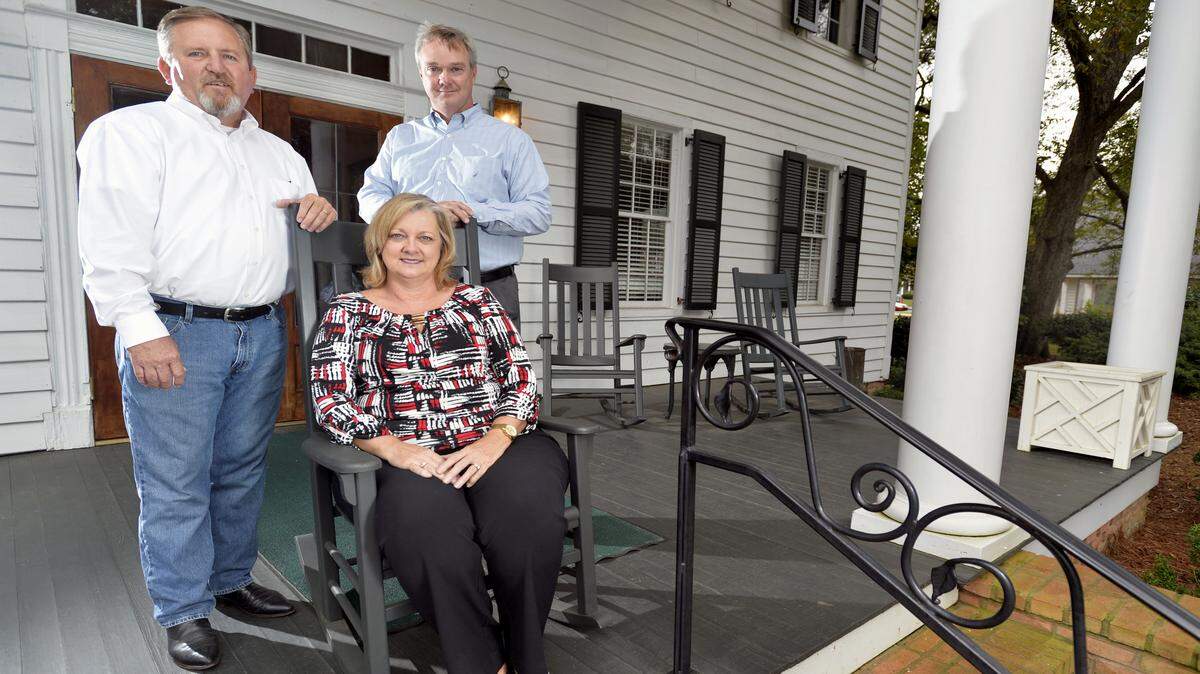The Retreat at Southern Bridle Farms and Carriage House restaurant owners, from left, David and Lynn Whiddon and Jim Marshall, stand outside the Carriage House in Perry.