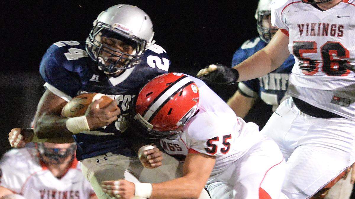 EVAN RODENROTH/For The TELEGRAPH,Warner Robins, Georgia, 10/02/2015: Stratford Eagle Kasey Sanders gets hit as he break through the line by FPD Viking Denson Martin.
