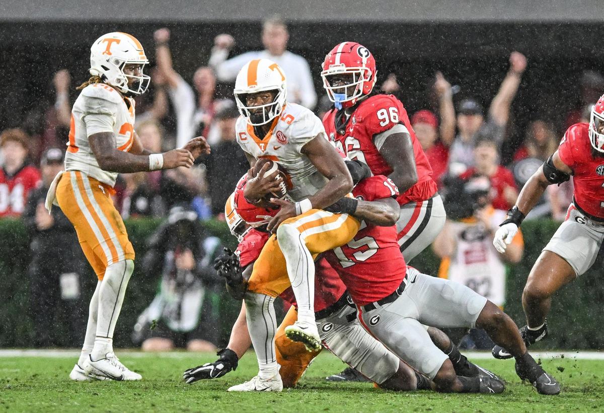 Tennessee quarterback Hendon Hooker gets sacked Trezmen Marshall as the rains fell at Sanford Stadium Saturday in Athens.