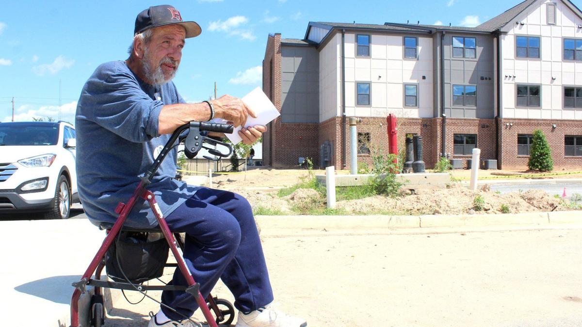Bobby Wagner, an applicant for a new shelter for homeless and low-income Macon residents, waits outside as the facility holds a blessing ceremony.