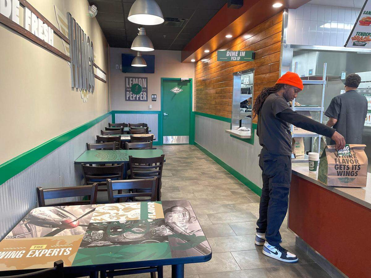 A DoorDash driver picks up an order at the new Wingstop in Perry.