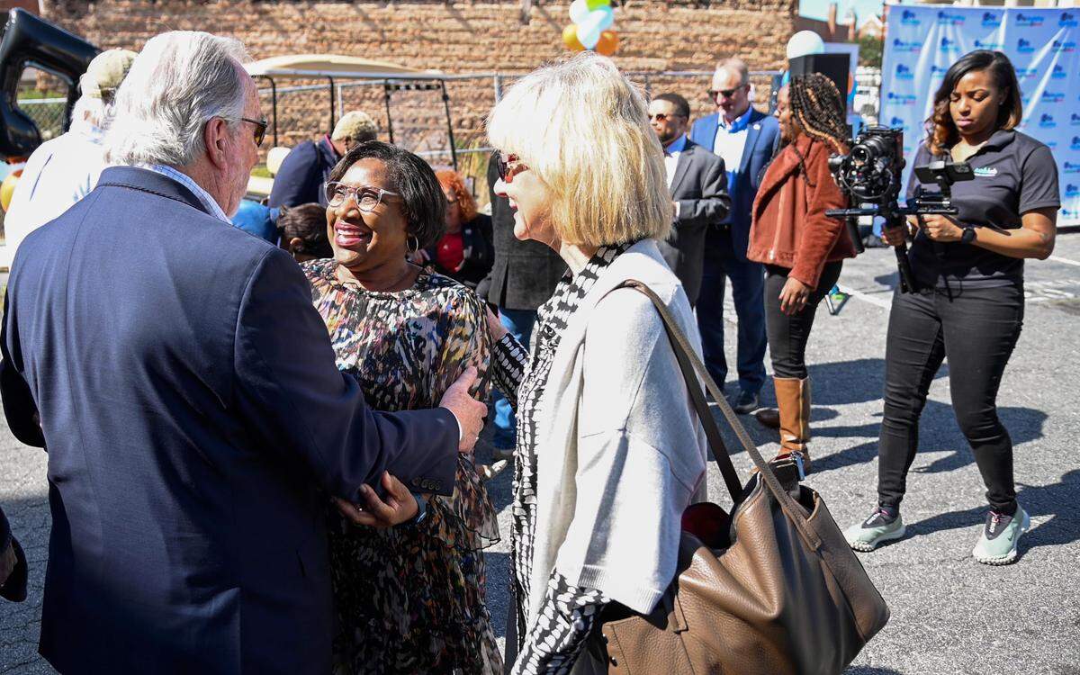 Karla Redding-Andrews, second from left, vice president and executive director of The Otis Redding Foundation greets guests Tuesday morning after the foundation announced the Otis Redding Center for the Arts will be built on Cotton Avenue.