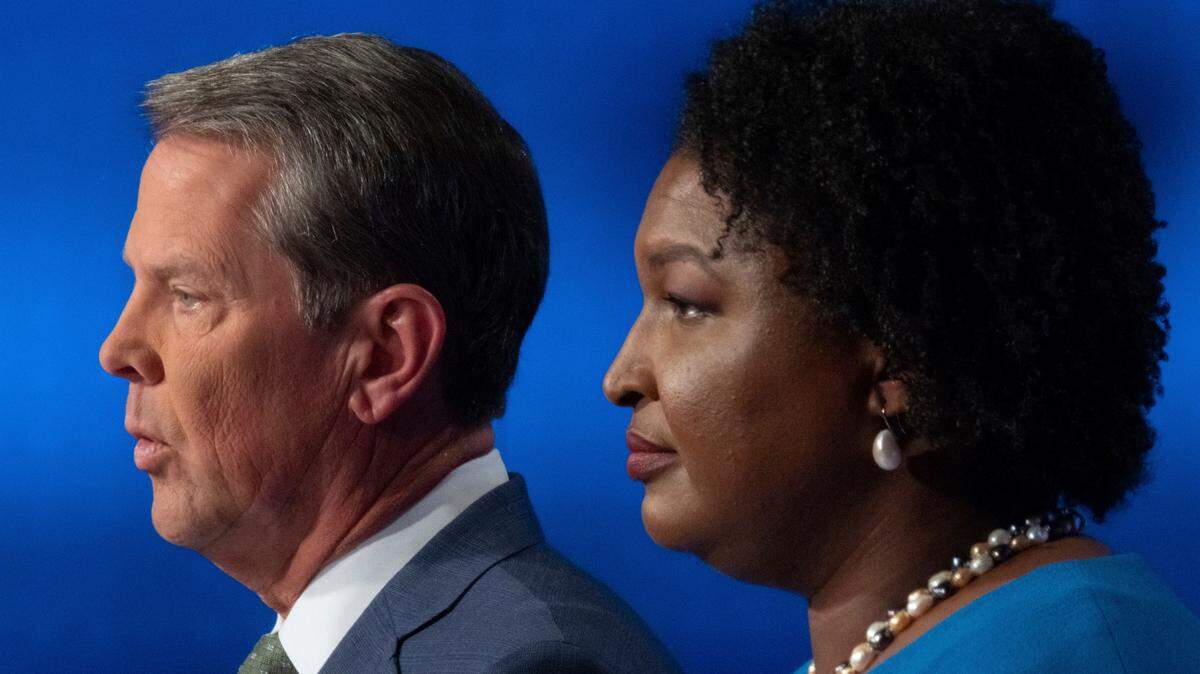 Republican Georgia Gov. Brian Kemp, left, and Democratic challenger Stacey Abrams face off in a televised debate, in Atlanta, Sunday, Oct. 30, 2022. (AP Photo/Ben Gray)