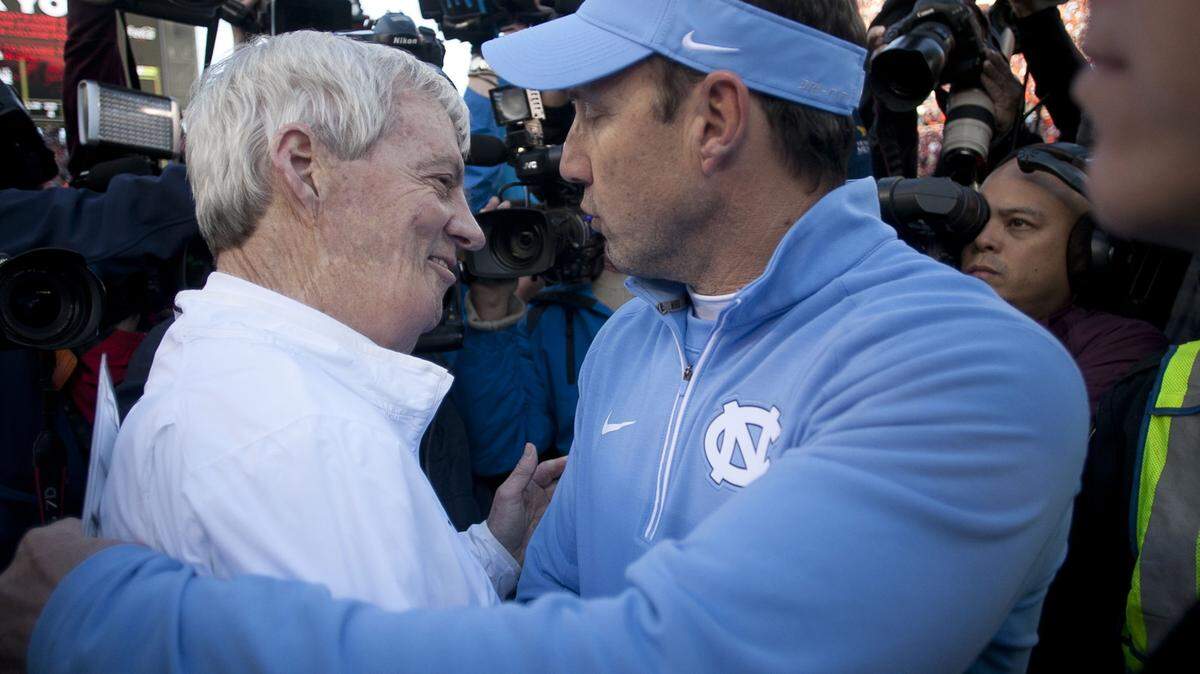 North Carolina head coach Larry Fedora, right, embraces Virginia Tech head coach Frank Beamer following the Tar Heels' 30-27 overtime victory on Saturday, Nov. 21, 2015, at Lane Stadium in Blacksburg, Va. UNC won, 30-27, in overtime.