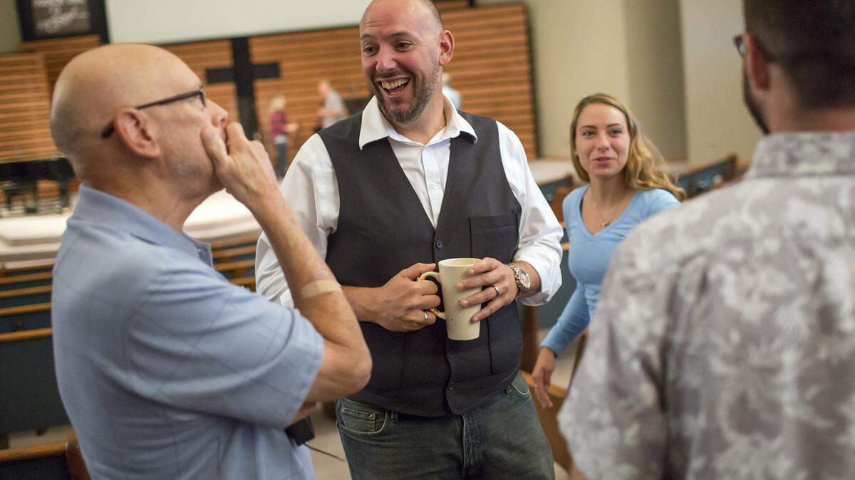 The Rev. Andrew Powell, second from left, greets parishioners at Grace Baptist Church in August in Mahomet, Illinois. Powell became Grace’s senior pastor in 2012 after the church used a minister search firm.