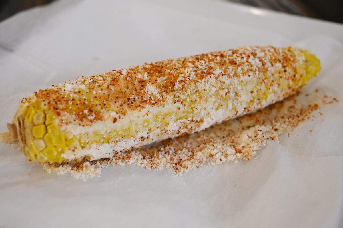 Street corn from Fuego Fresco Mexican Restaurant on Thursday, Aug. 28, 2025, in Perry, Georgia. The dish features corn on the cob covered in cotija cheese, mayonnaise and Tajin.