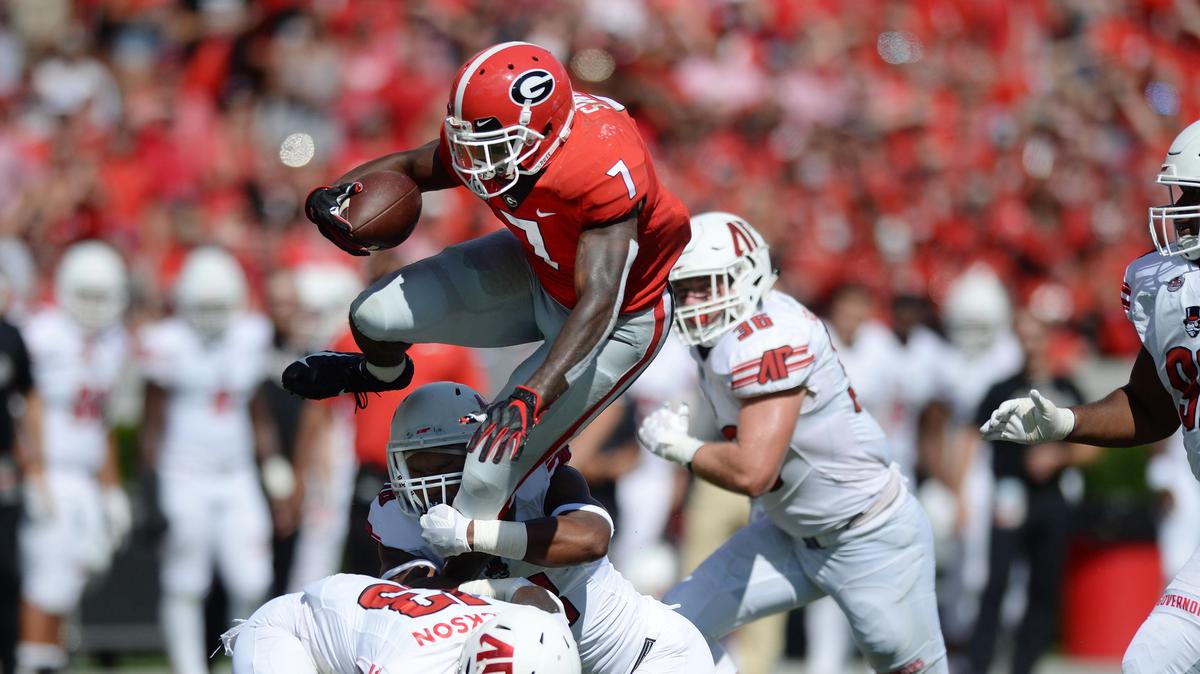 Georgia running back D’Andre Swift (7) is caught from behind as he leaps over Austin Peay defensive back Kordell Jackson en route to a first down.  The Bulldogs rushed for 284 yards and averaged 8.6 yds. per carry.  The Bulldogs beat the Governors 45-0 on Sept. 1.