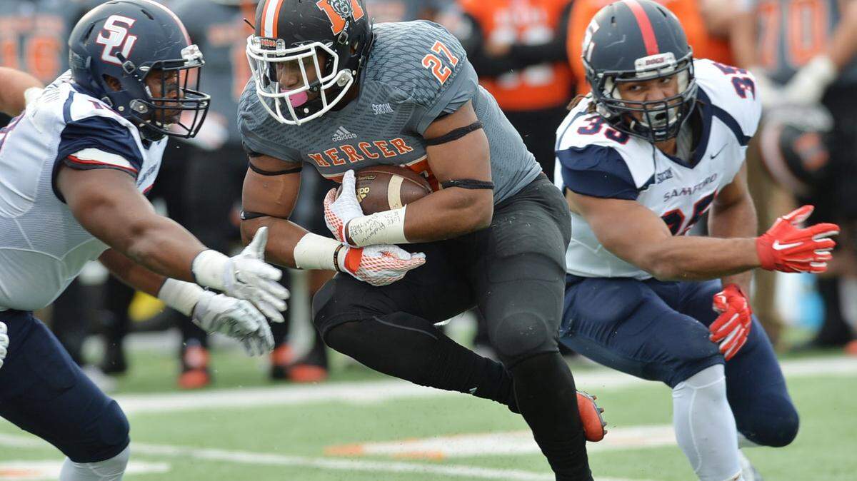 Mercer running back Alex Lakes blasts through the Samford defense en route to a first down.